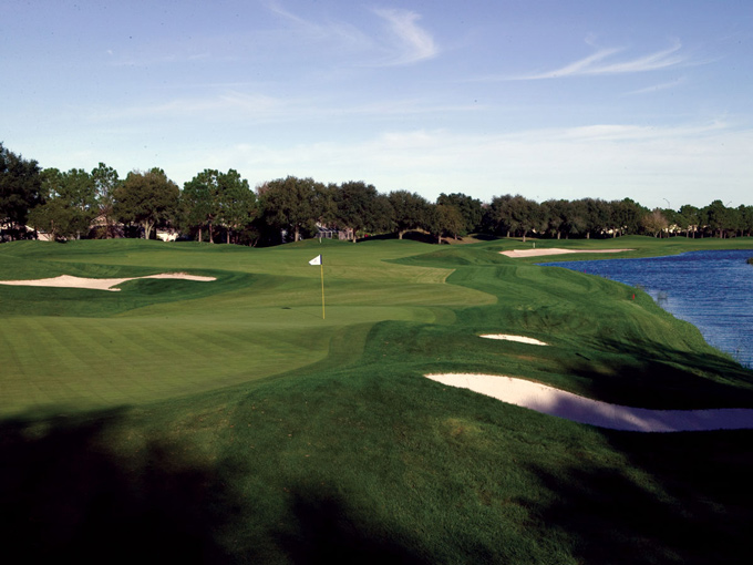 Difficult approach shot guarded by bunkers and lakes at TPC Tampa Bay